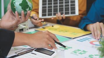 People working on a project with a green globe and other items video