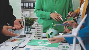Business people working together on a table with a green globe video