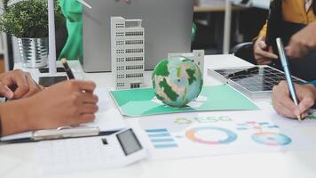 People working on a project with a globe on the table video