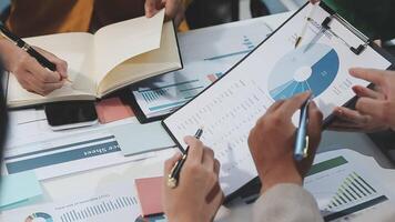Business people working on a document with graphs and papers video