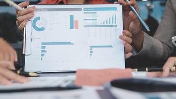 Business people holding a piece of paper with graphs on it video
