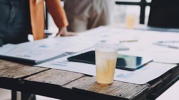 A glass of juice is sitting on a table in a meeting room video