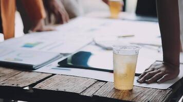 A group of people sitting at a table with a drink video