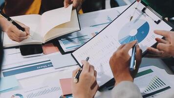 Business people working on a document with graphs and papers video