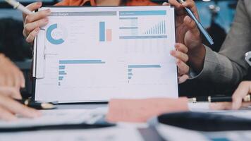 Business people holding a piece of paper with graphs on it video