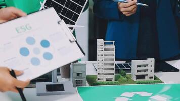 People are looking at a paper with a model of a recycling sign video