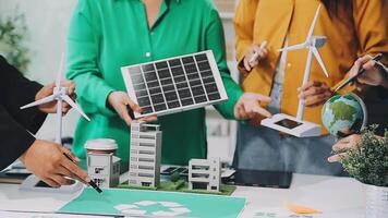 A group of people working on a project with solar panels and wind turbines video