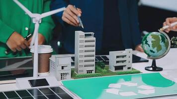 A group of people are working on a project that includes a recycling model video