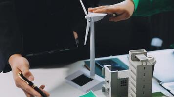 A person is holding a wind turbine on a table video