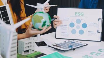 Business people working on a project with an esg chart video