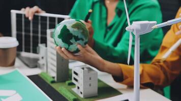 People working on a project with a wind turbine video