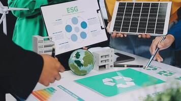 People working on a table with a solar panel and other items video