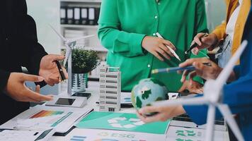 Business people working together on a table with a green globe video