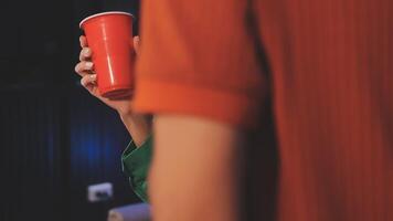 A person holding a red cup in front of them video