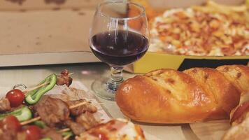 A pizza, bread, and wine on a table video