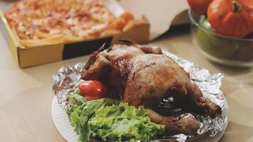 A chicken is sitting on a plate with a salad and pizza video