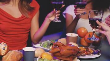 A group of people toasting with wine at a dinner table video