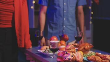 A man and woman standing near a table with food video
