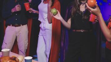 A group of people standing around a table with drinks video