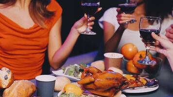 A group of people toasting with wine at a dinner table video