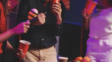 A group of people standing around a table with drinks video