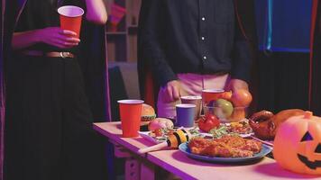 A couple standing in front of a table with food video