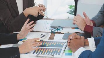 Business people at a table with papers and pens video