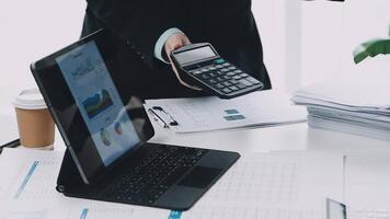 Businessman using a calculator to calculate the cost of a project video