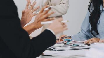 Business people at a meeting with their hands up video