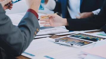 Business people at a table with papers and pens video
