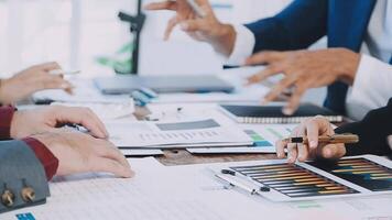 Business people at a table with papers and pens video