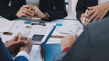 Business people at a table with papers and pens video
