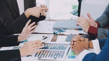 Business people at a table with papers and pens video