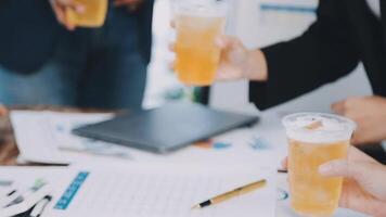 Business people toasting with drinks on a table video