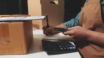 A person is using a calculator and a pen to write on a piece of paper video