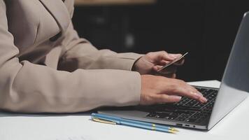 A person using a laptop computer with a credit card video
