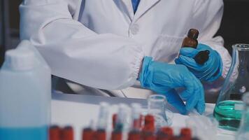 A person in a lab coat and gloves is working on something video