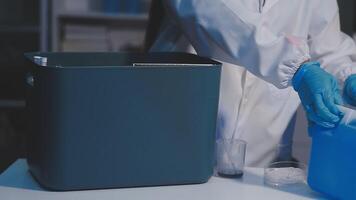 A person in a lab coat is holding a container video