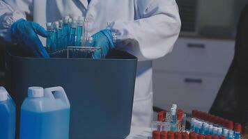 A person in a lab coat is holding a container video