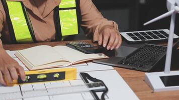 A woman working on a laptop and using a calculator video