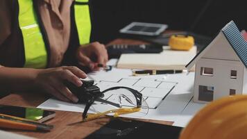 A person working on a house model with construction tools video