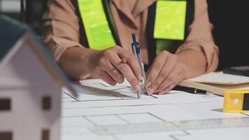 A person is working on a blueprint with a ruler and a pencil video