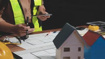 A person is working on a blueprint for a house video