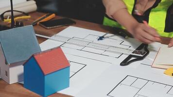 A person is working on a blueprint with a house on it video
