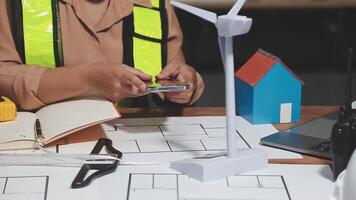 A woman is using her cell phone while working on a project video