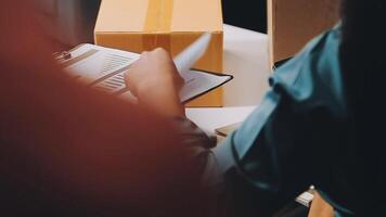 A person is writing on a piece of paper while sitting at a desk video