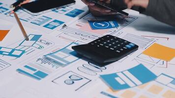 A person using a calculator on a table with a lot of business documents video
