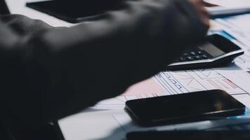 A person is using a calculator on a desk video