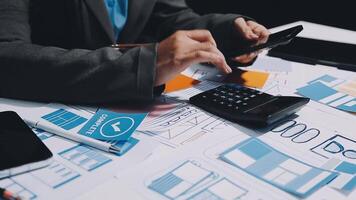 Businessman using calculator and phone to calculate video