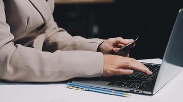 A person using a laptop computer with a credit card video